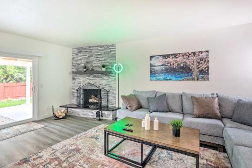 a living room with a couch and a fireplace at Relax Fireside and Play Pool! Home 4 Mi to Dtwn Reno in Reno