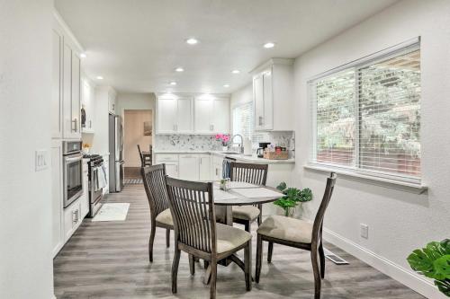 a kitchen with a dining room table and chairs at Relax Fireside and Play Pool! Home 4 Mi to Dtwn Reno in Reno