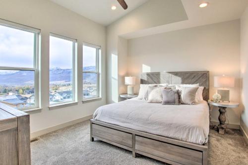 a bedroom with a large bed with two windows at Eden Home with Stunning View about 6 Mi to Skiing! in Eden