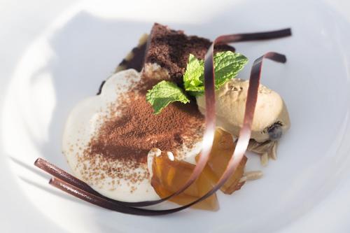 a plate of food with an egg and chocolate at Hospes Maricel y Spa, Palma de Mallorca, a Member of Design Hotels in Cas Catala