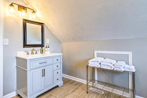 a bathroom with a sink and a mirror and towels at Pet-Friendly Indianapolis Townhome with Yard! in Indianapolis