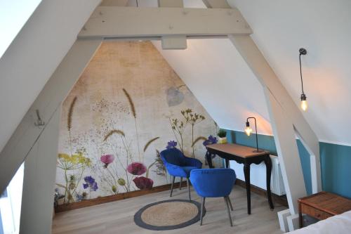 Cette chambre est ornée d'une fresque murale représentant des fleurs. dans l'établissement le DOMAINE D HELANT, à Ecquedecques