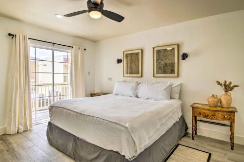 a bedroom with a bed with a ceiling fan and a window at South Padre Island Getaway - Newly Renovated! in South Padre Island