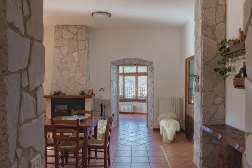 a living room filled with furniture and a window at Ostello-Albergo dagli Elfi in Barrea