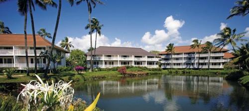 a resort with a lake in front of some buildings at Oceanview 1BR at Kiahuna Plantation Unit 170 in Koloa