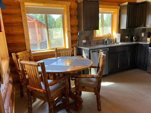 a kitchen with a table and chairs in a cabin at North Haven Campground in Bonners Ferry