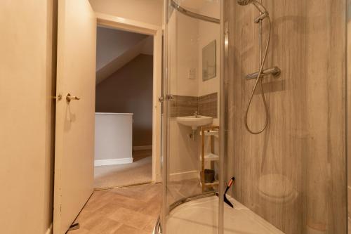 a bathroom with a shower and a sink at Fishertown House in Nairn