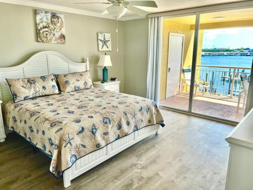 a bedroom with a bed and a view of the water at 2x2 Fully Updated Old Town Waterfront Corner Condo in Key West