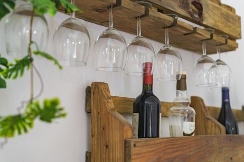 a bunch of wine glasses hanging on a wall at Ostello-Albergo dagli Elfi in Barrea