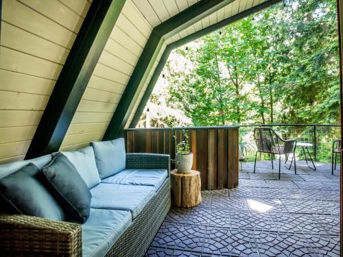 a screened in porch with a couch and a table at Alpine Lodge in Glacier