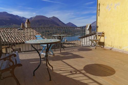 a balcony with two tables and a view of the mountains at Ostello-Albergo dagli Elfi in Barrea