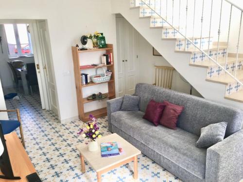 a living room with a couch and a table at Casa Azul em Alcantarilha - Algarve in Alcantarilha