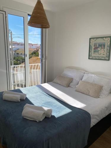a bedroom with a large bed with two pillows on it at Casa Azul em Alcantarilha - Algarve in Alcantarilha