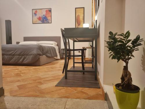 a bedroom with a desk and a chair and a table at G.S House in LʼAquila