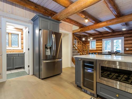a kitchen with stainless steel appliances and wooden ceilings at ArborMyst in Glacier