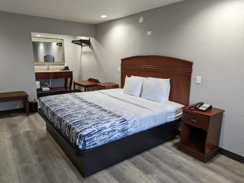a hotel room with a bed and a sink at OKC Hotel in Oklahoma City