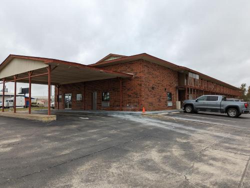 a brick building with a truck parked in a parking lot at OKC Hotel in Oklahoma City