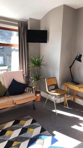 a living room with a couch and a chair at The Cross Inn in Hebden Bridge
