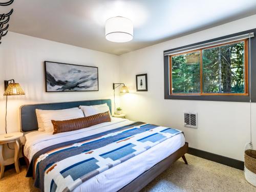 a bedroom with a large bed and a window at Pendleton Pines Lodge in Glacier