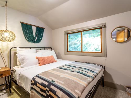 a bedroom with a bed and a window at Pendleton Pines Lodge in Glacier