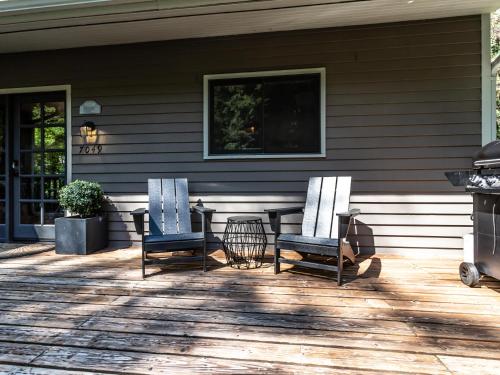 two chairs sitting on a front porch of a house at Pendleton Pines Lodge in Glacier