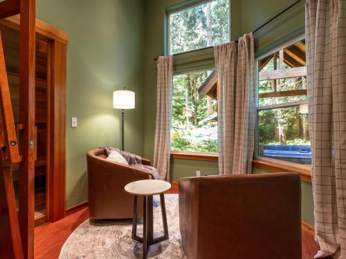 a living room with two chairs and a window at Heliotrope Haus in Glacier