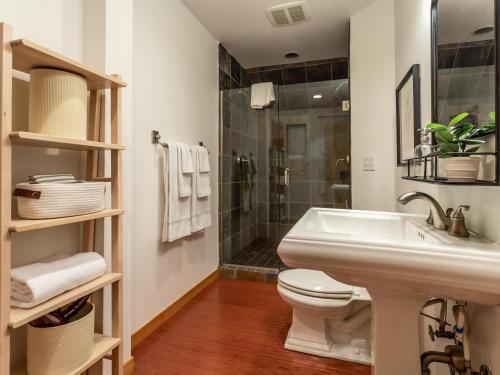 a bathroom with a sink and a toilet and a shower at Heliotrope Haus in Glacier