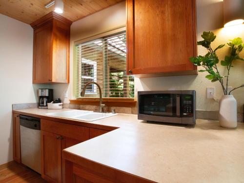 a kitchen with a sink and a microwave at Heliotrope Haus in Glacier