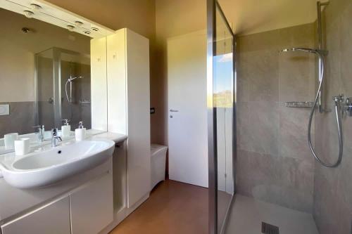 a bathroom with a sink and a shower at casale dei cinque colli APPARTAMENTO in Ostra