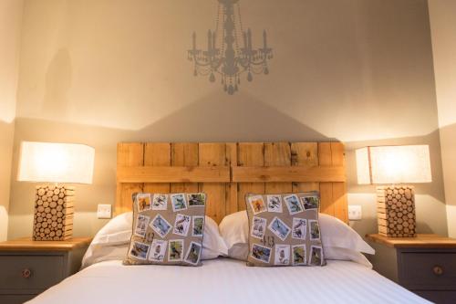 een slaapkamer met een bed met 2 lampen en een kroonluchter bij The King's Head in Winchester