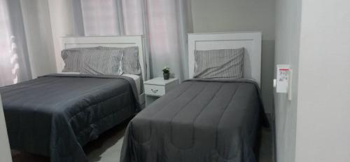 two beds in a small room withskirts at Apartahotel MACADANA in Nagua