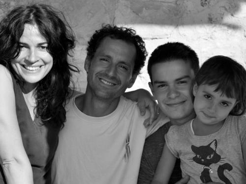 a black and white photo of a family posing for a picture at Fattoria Bio L'A Ceccoli in Sassofeltrio