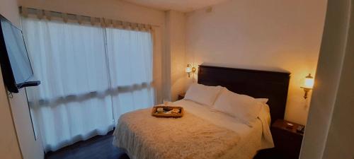 A bed or beds in a room at Departamento Godoy Cruz Mendoza