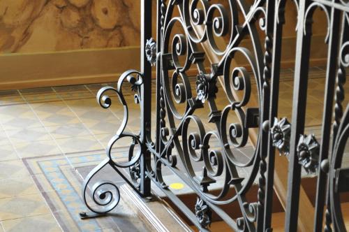 a black metal gate in a room with a tile floor at Penzion Lípa in Krásná Lípa