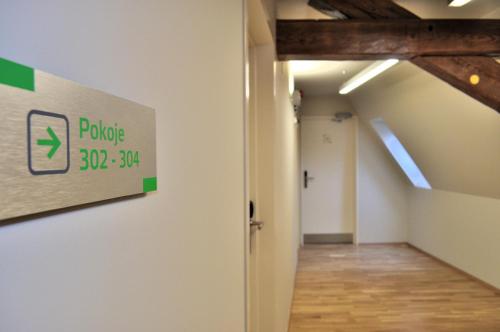 an empty hallway with a sign on the wall at Penzion Lípa in Krásná Lípa