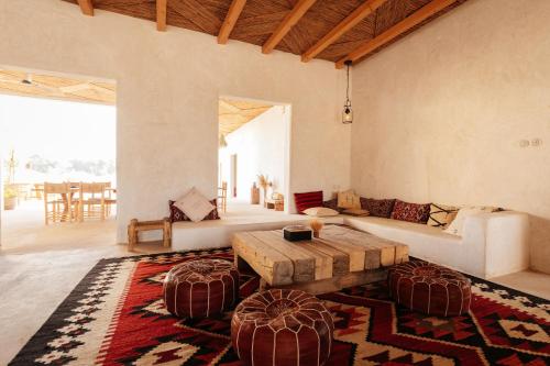 a living room with a table and a couch at Heenat Salma Farm in Mu‘askar al Buşayyir