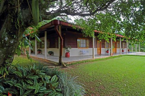 a house with a green lawn in front of it at Argovia Ecolodge in Tapachula
