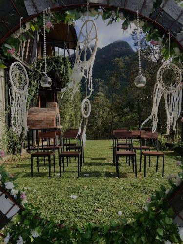 a group of chairs and a table in a field at The Backyard Balangoda in Balangoda