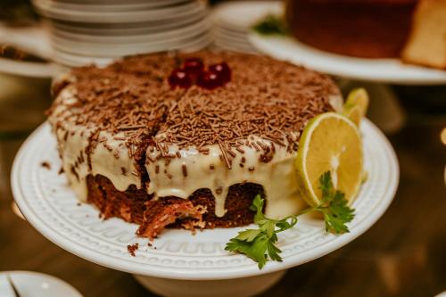 a cake on a plate on a table at Vitoria Praia Hotel in Vitória