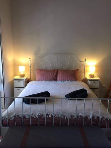 a bedroom with a large bed with two night stands at Little Summer Chalet in Saronida