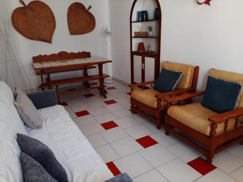 a living room with chairs and a couch and a table at Apartamentos Cavaco in Odeceixe