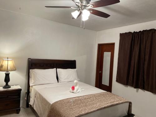 a teddy bear sitting on a bed in a bedroom at Luxurious One and Two Bedroom Villa in Christiansted