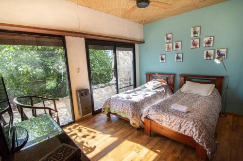 Postel nebo postele na pokoji v ubytování Sudeste Asiático con Pileta sobre el Rio Paraná