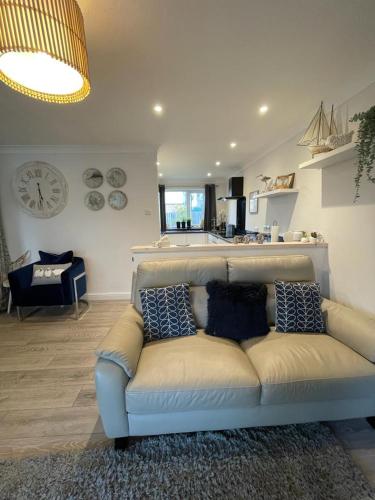 a living room with a couch with pillows on it at Holiday home, Tywyn, great location in Tywyn