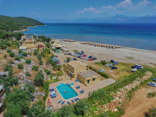 an aerial view of a resort with a pool and a beach at Nikos Kalamaki Corfu in Apraos