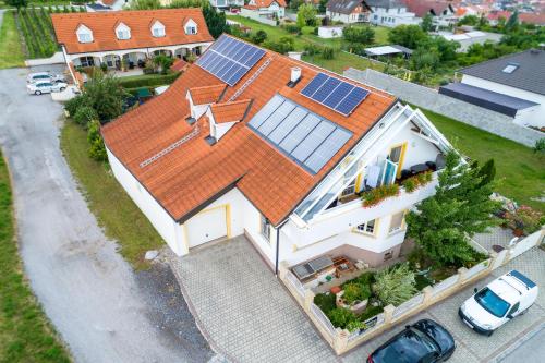 an aerial view of a house with solar panels on it at Appartementhaus Martina in Mörbisch am See