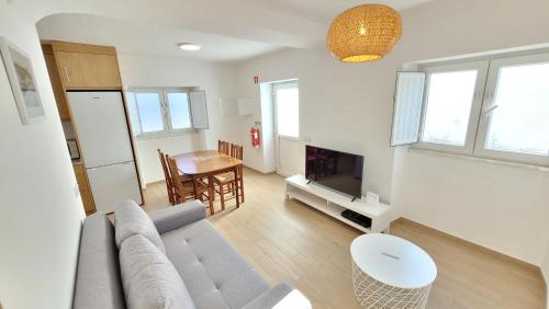 a living room with a couch and a table at Casa da Costureira in Brejao