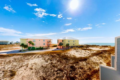 a view of three houses on the beach at Fort Morgan Townhomes E1 in Fort Morgan