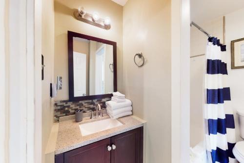a bathroom with a sink and a mirror at Fort Morgan Townhomes E1 in Fort Morgan