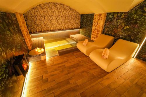 a living room with a couch and a chair at Hotel Il Guercino in Bologna